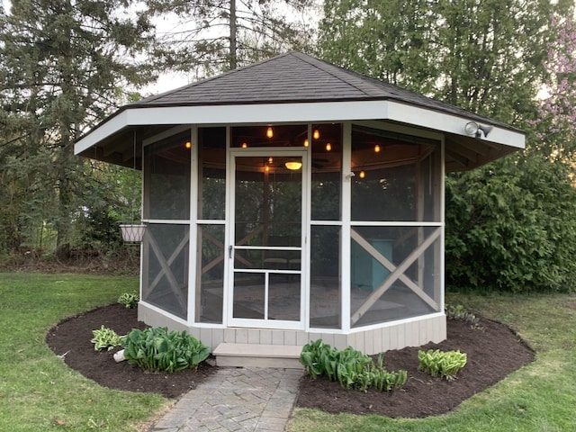 view of outdoor structure with a sunroom