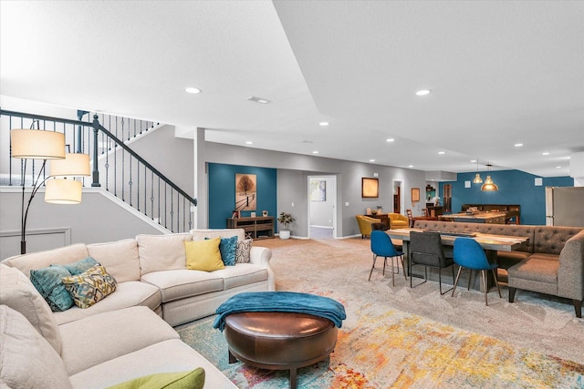 carpeted living room featuring stairway and recessed lighting