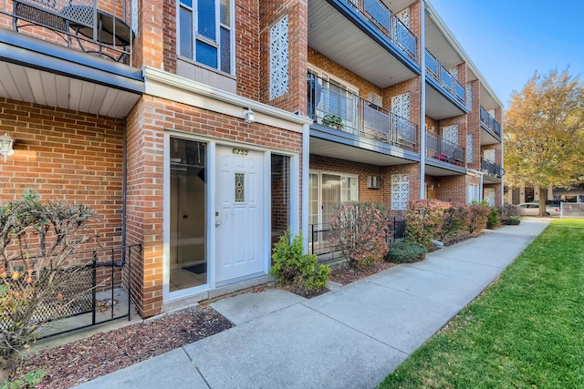 view of exterior entry with brick siding