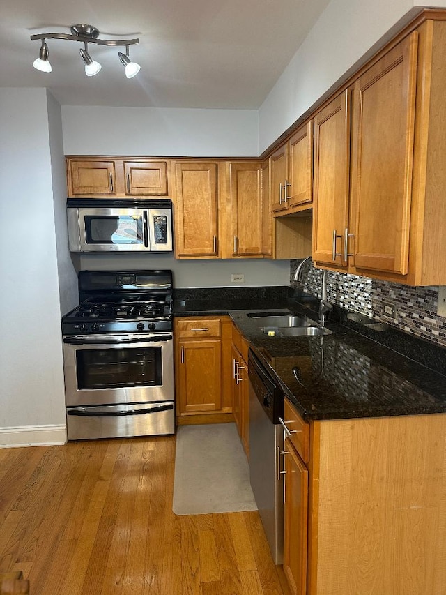 6255 S Mason Ave Unit 3D, Chicago, IL 60638 - kitchen featuring a sink, appliances with stainless steel finishes, brown cabinetry, and light wood-type flooring