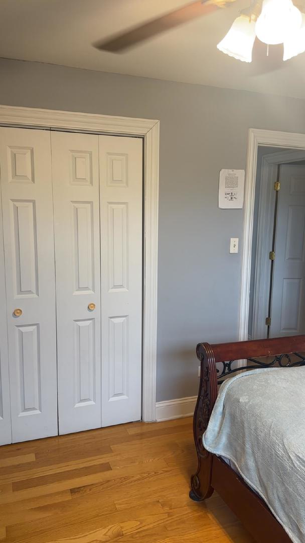 6255 S Mason Ave Unit 3D, Chicago, IL 60638 - bedroom with a closet, baseboards, a ceiling fan, and light wood-type flooring