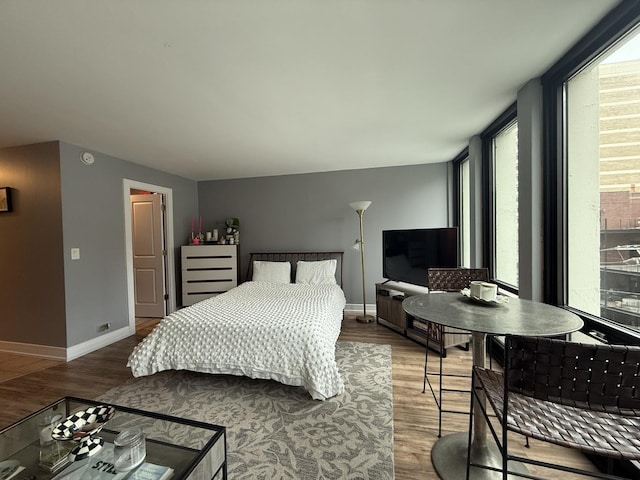 bedroom featuring baseboards and wood finished floors