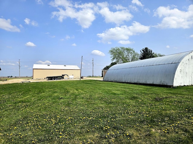 8554 S Daysville Rd, Franklin Grove, IL 61031 - view of green lawn featuring a pole building and an outdoor structure