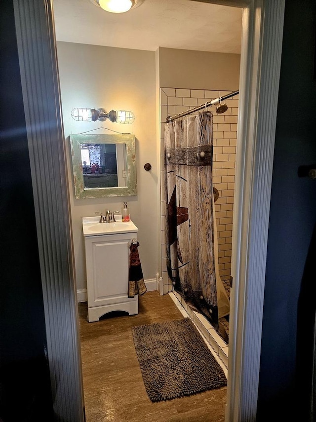 8554 S Daysville Rd, Franklin Grove, IL 61031 - full bath with a shower stall, wood finished floors, vanity, and baseboards