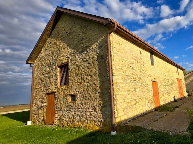 8554 S Daysville Rd, Franklin Grove, IL 61031 - view of home's exterior with stone siding and a lawn