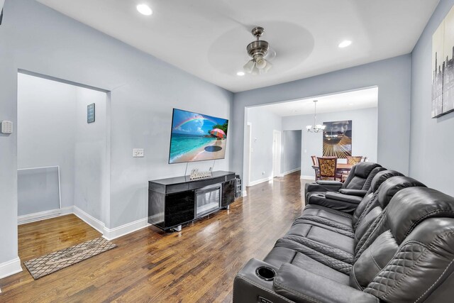 living area featuring baseboards, ceiling fan with notable chandelier, recessed lighting, and wood finished floors