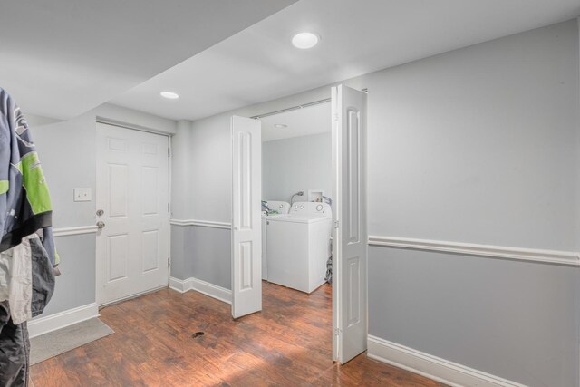 laundry room with baseboards, laundry area, wood finished floors, and washer and clothes dryer