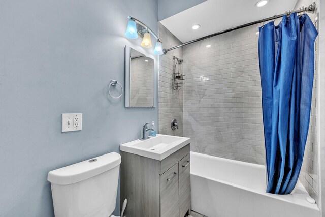 bathroom featuring vanity, recessed lighting, shower / bath combo, and toilet