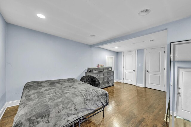 bedroom featuring baseboards, recessed lighting, and wood finished floors