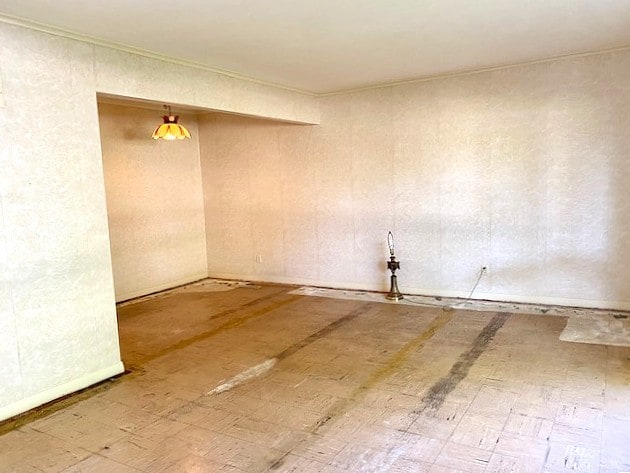 empty room featuring crown molding
