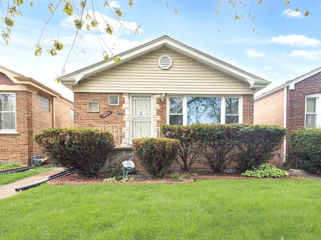 14216 S Normal Ave, Riverdale, IL 60827 - bungalow-style house featuring brick siding and a front lawn