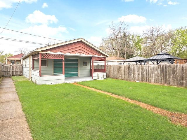 14216 S Normal Ave, Riverdale, IL 60827 - exterior space featuring a lawn, a porch, a gazebo, and a fenced backyard