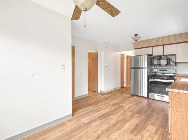 14216 S Normal Ave, Riverdale, IL 60827 - kitchen with baseboards, light wood-type flooring, light countertops, a ceiling fan, and appliances with stainless steel finishes