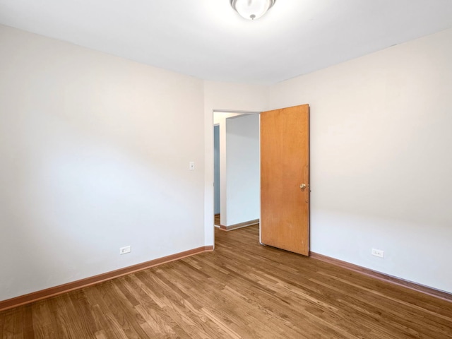 14216 S Normal Ave, Riverdale, IL 60827 - unfurnished room featuring baseboards and light wood-type flooring