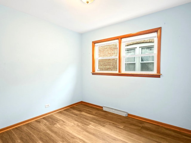 14216 S Normal Ave, Riverdale, IL 60827 - empty room featuring baseboards, wood finished floors, and visible vents