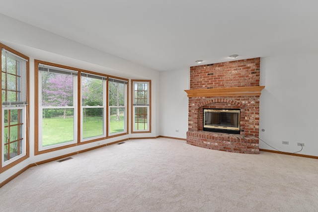 unfurnished living room featuring visible vents, baseboards, and a healthy amount of sunlight