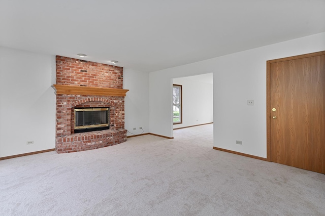 unfurnished living room with baseboards, carpet flooring, and a brick fireplace