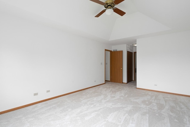 unfurnished room featuring light colored carpet, lofted ceiling, baseboards, and a ceiling fan
