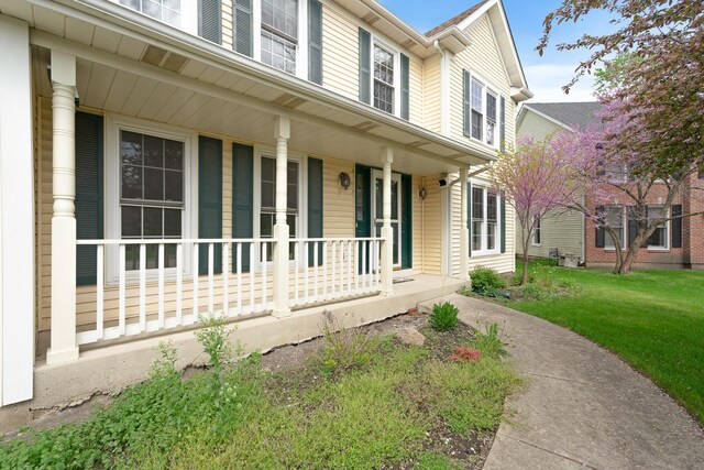exterior space featuring a porch and a lawn