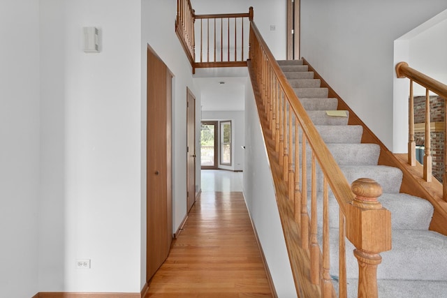 staircase featuring wood finished floors