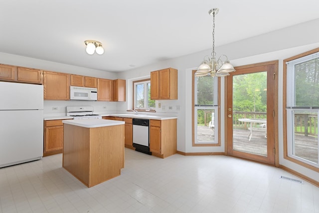 kitchen featuring baseboards, white appliances, an inviting chandelier, visible vents, and light countertops