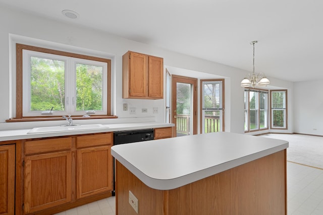 kitchen with brown cabinets, a sink, pendant lighting, light countertops, and a chandelier