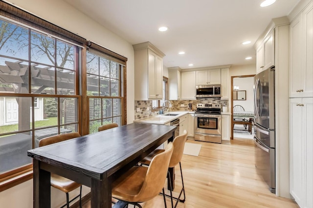 1608 N Douglas Ave, Arlington Heights, IL 60004 - kitchen featuring stainless steel appliances, a sink, light wood-style floors, backsplash, and recessed lighting