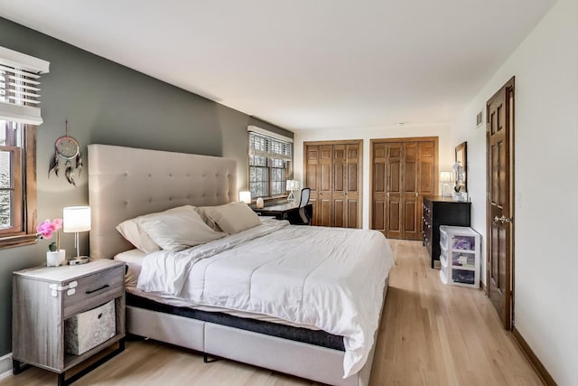 1608 N Douglas Ave, Arlington Heights, IL 60004 - bedroom featuring multiple closets, light wood-type flooring, and baseboards