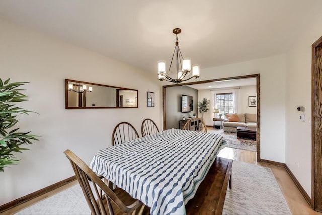 1608 N Douglas Ave, Arlington Heights, IL 60004 - dining space with a chandelier, light wood-style floors, and baseboards