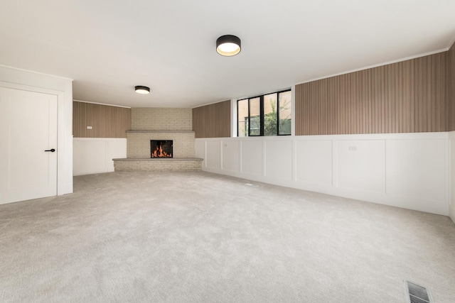 1528 S Ashland Ave, Park Ridge, IL 60068 - unfurnished living room with visible vents, carpet flooring, a decorative wall, and a fireplace