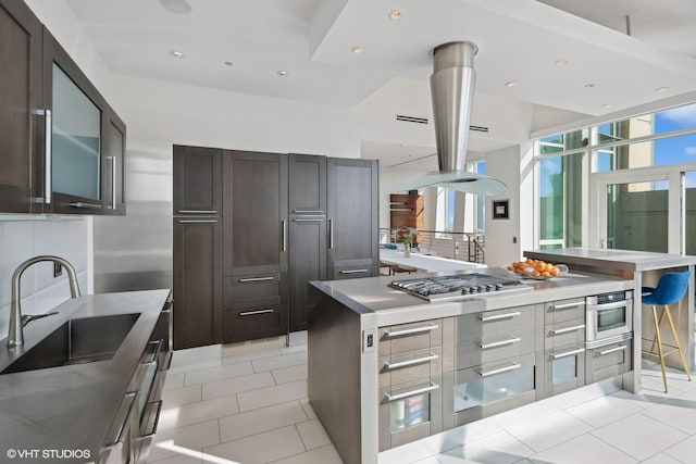 kitchen featuring stainless steel gas stovetop, light tile patterned floors, a sink, and light countertops