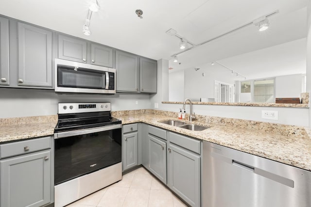 345 N La Salle Dr Unit 1205, Chicago, IL 60610 - kitchen featuring a sink, rail lighting, gray cabinetry, and stainless steel appliances