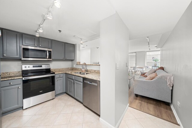 345 N La Salle Dr Unit 1205, Chicago, IL 60610 - kitchen with track lighting, a sink, gray cabinets, and appliances with stainless steel finishes