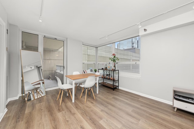 345 N La Salle Dr Unit 1205, Chicago, IL 60610 - dining space with baseboards, rail lighting, and wood finished floors