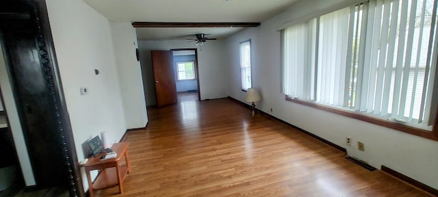 unfurnished room with baseboards, light wood-style flooring, and ceiling fan