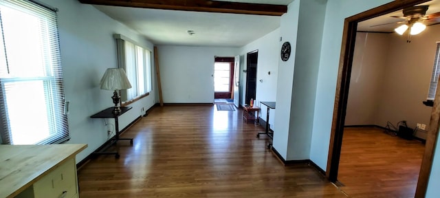 corridor with wood finished floors and baseboards