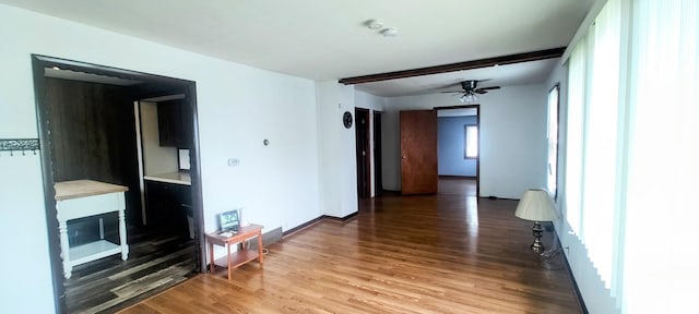 unfurnished living room with wood finished floors and ceiling fan