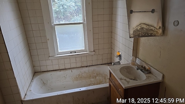 bathroom with vanity and a washtub