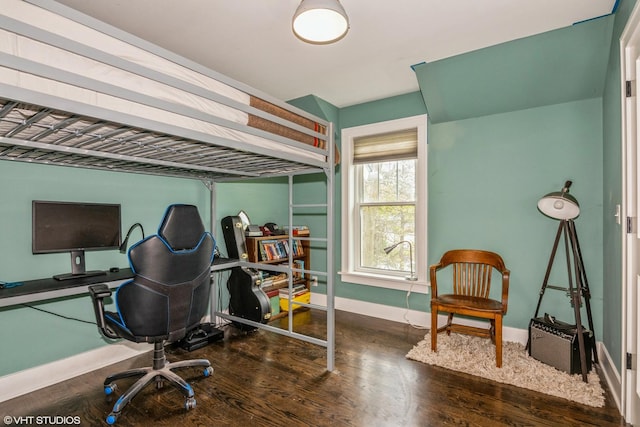 bedroom featuring baseboards and wood finished floors