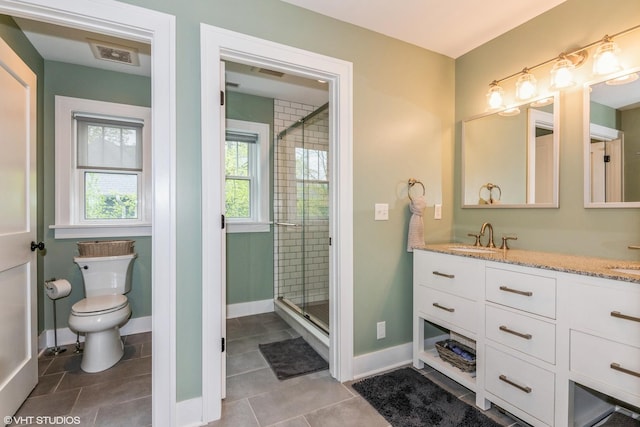 bathroom featuring toilet, tile patterned flooring, vanity, and a stall shower