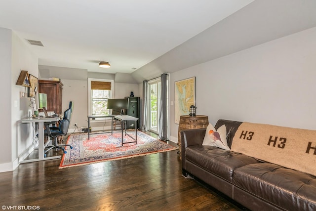 living room featuring visible vents, wood finished floors, and baseboards