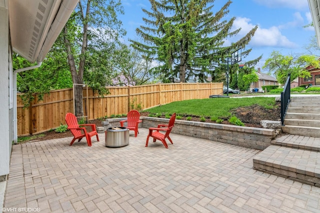 view of patio / terrace with an outdoor fire pit and fence