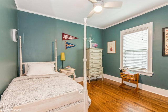 bedroom with crown molding, baseboards, a ceiling fan, and wood finished floors
