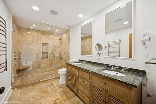 1050 Cedar Ln, Lake Forest, IL 60045 - bathroom featuring a shower stall, double vanity, toilet, a towel warming rack, and recessed lighting