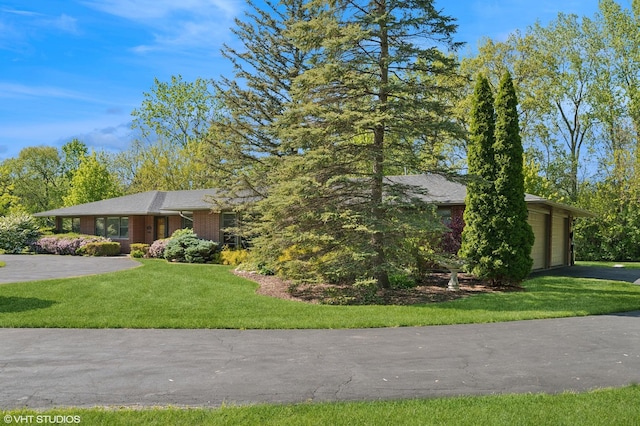 1050 Cedar Ln, Lake Forest, IL 60045 - view of front facade featuring a front yard, brick siding, and driveway