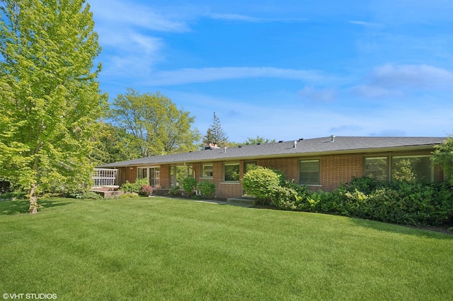 1050 Cedar Ln, Lake Forest, IL 60045 - rear view of house with a lawn and brick siding