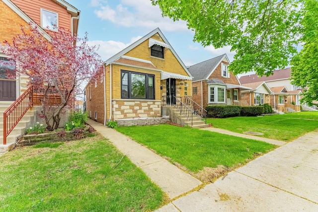 bungalow-style house featuring stone siding, a front lawn, and brick siding