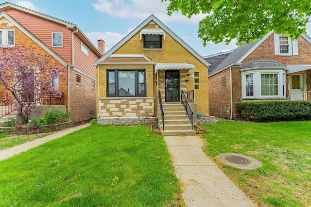 view of front of house featuring a front yard and brick siding