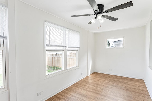 unfurnished room featuring a wealth of natural light, baseboards, ceiling fan, and light wood-style floors
