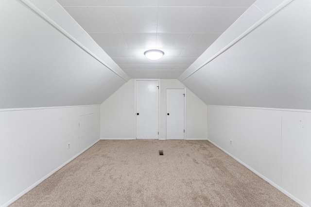 bonus room with carpet, baseboards, and lofted ceiling